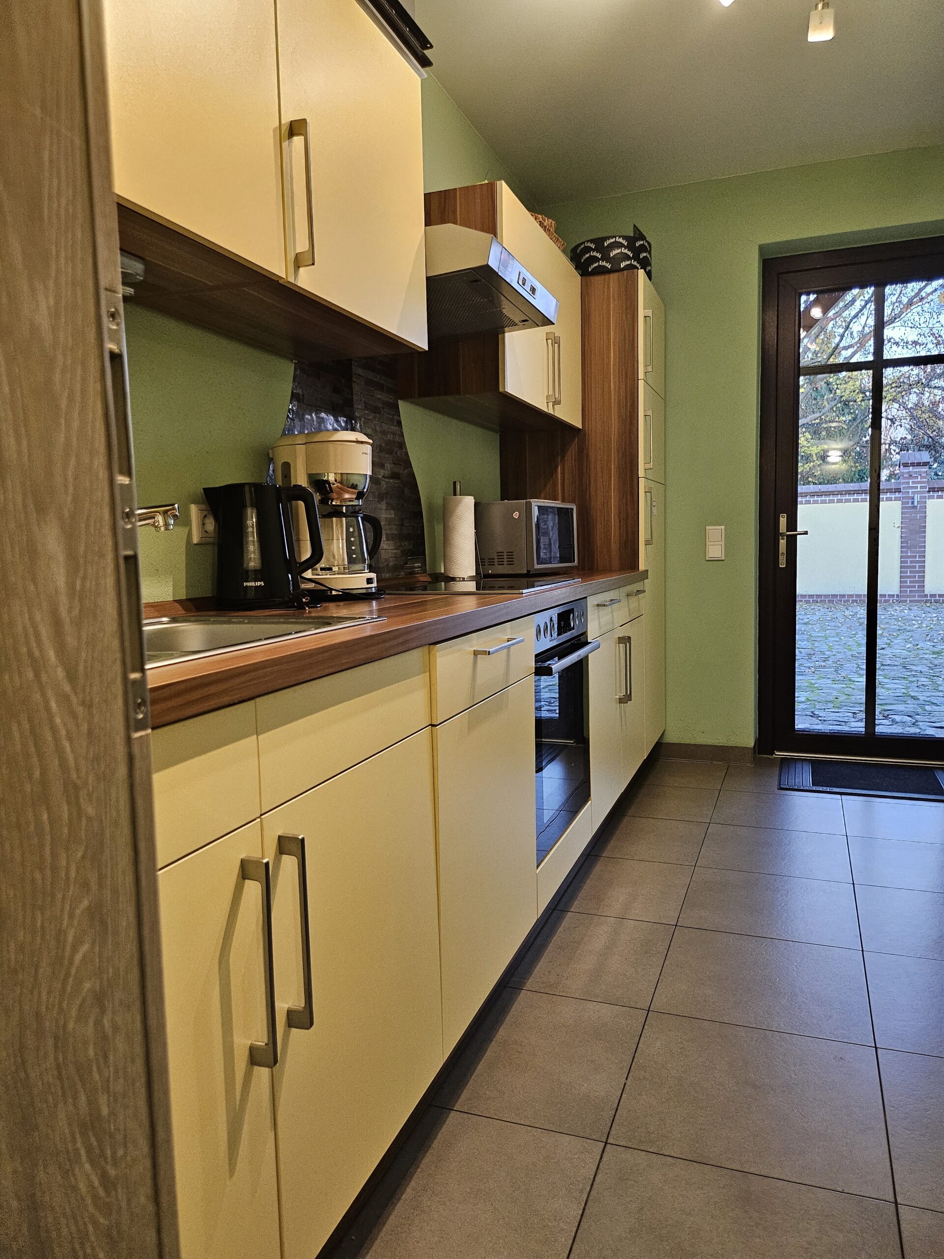 Voll ausgestattete Küche mit Herd und Kaffeemaschine